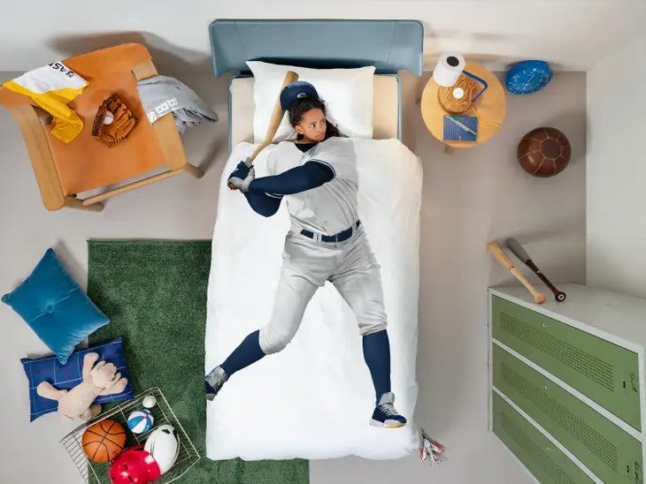 Bedding set with a baseball player design in a child's bedroom.