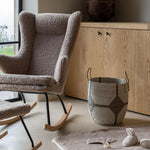 A Quax Rocking Chair Deluxe with a stone color teddy fabric cover