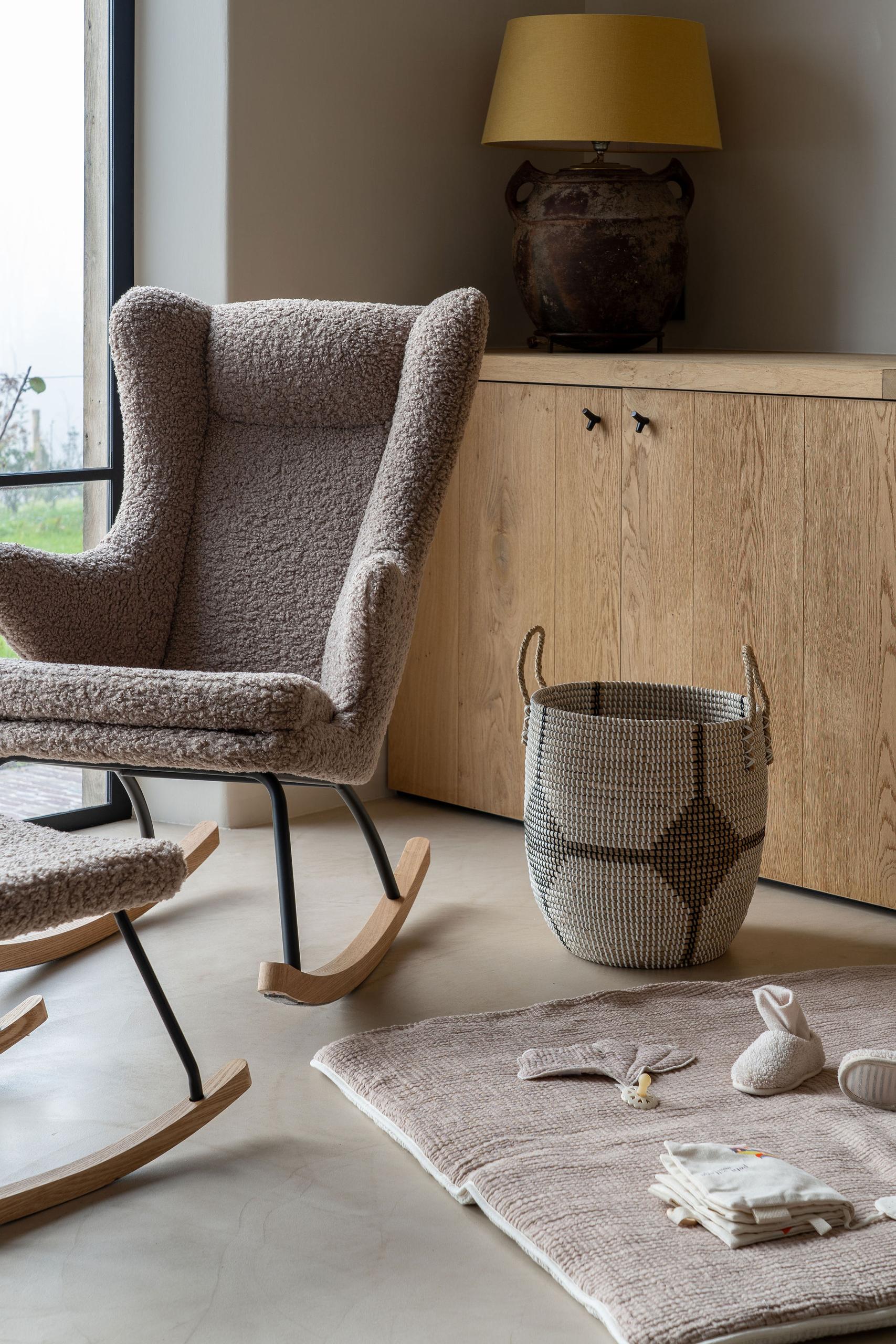 A Quax Rocking Chair Deluxe with a stone color teddy fabric cover