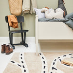 A rug with a race track pattern in beige, white, and black colour, kids rugs singapore