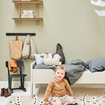 A rug with a race track pattern in beige, white, and black colour, kids rugs singapore
