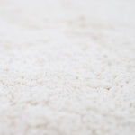 A round beige cotton rug with a lace finish, kids rugs and carpets singapore