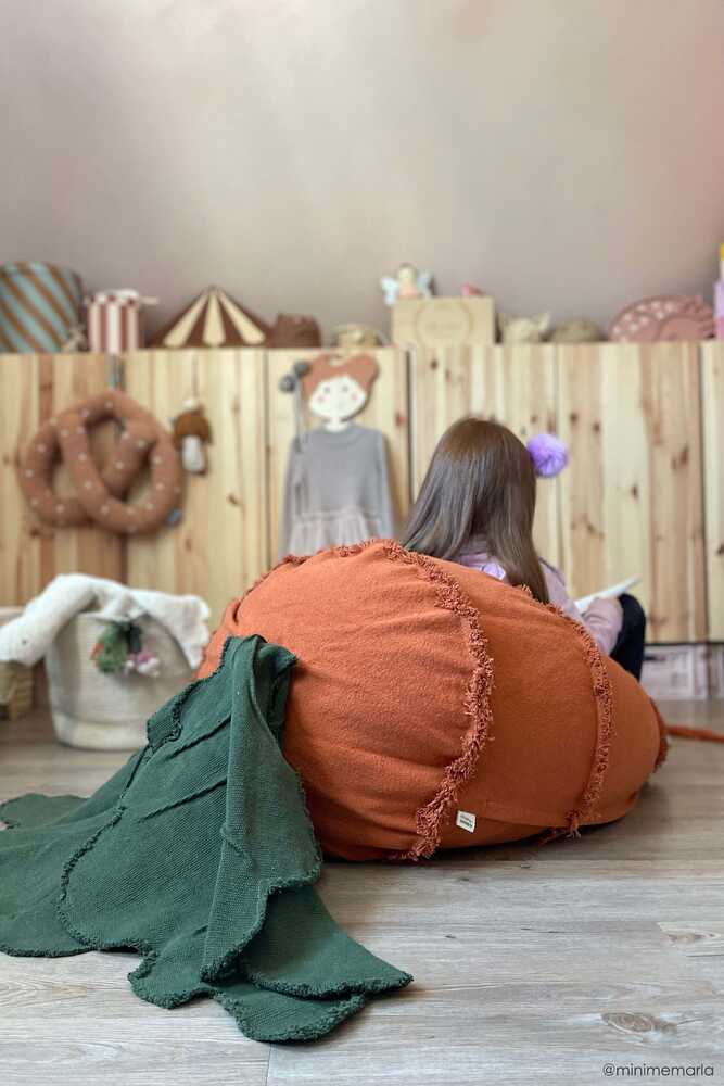 A large, orange, carrot-shaped bean bag with a green leaf on top, made of cotton fabric, kids bean bags and poufs singapore