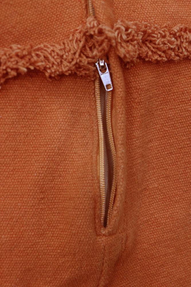 A large, orange, carrot-shaped bean bag with a green leaf on top, made of cotton fabric, kids bean bags and poufs singapore