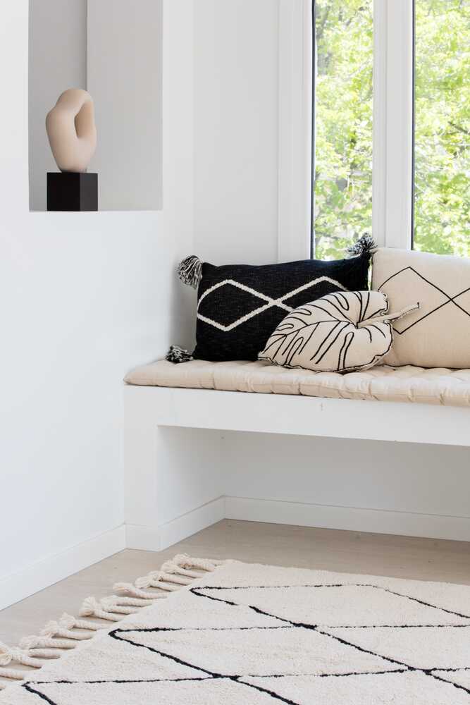 A beige and black geometric patterned washable rug with tassels on the border, kids rugs singapore