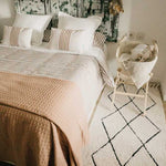 A beige and black geometric patterned washable rug with tassels on the border, kids rugs singapore