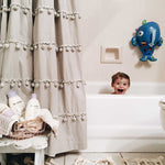 A beige and black geometric patterned washable rug with tassels on the border, kids rugs singapore