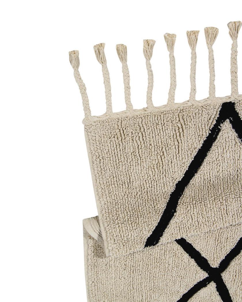 A beige and black geometric patterned washable rug with tassels on the border, kids rugs singapore