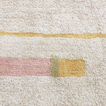 A rectangular, flatweave washable rug in beige, pink, and gray tones with a minimalistic geometric pattern, kids rugs and carpets singapore