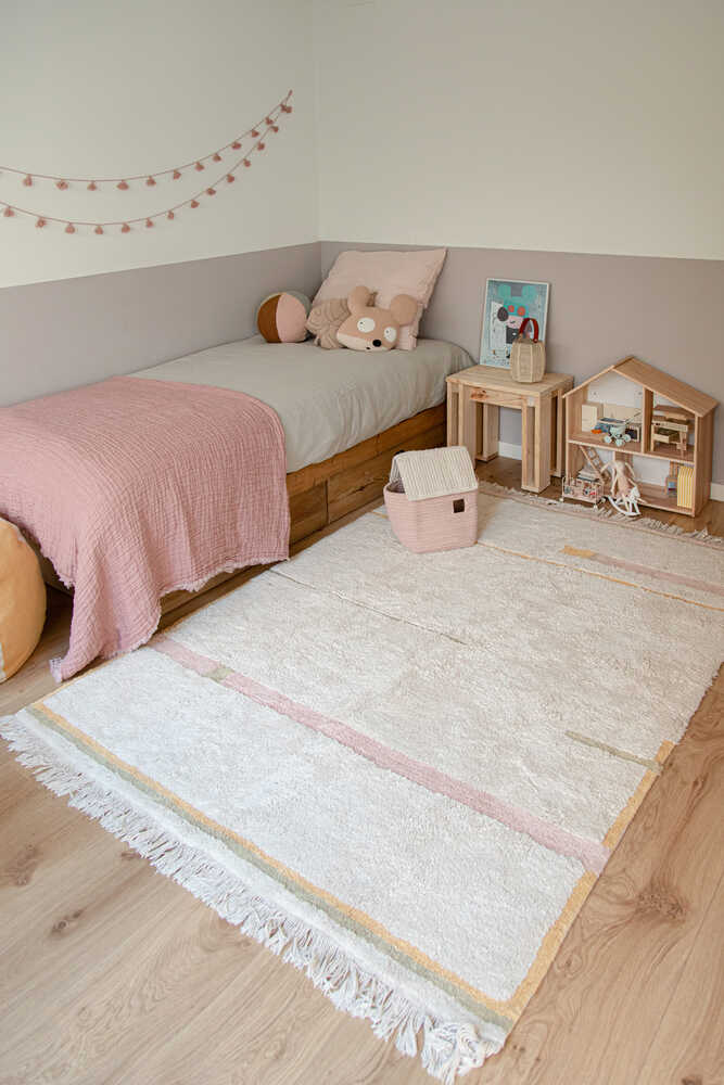 A rectangular, flatweave washable rug in beige, pink, and gray tones with a minimalistic geometric pattern, kids rugs and carpets singapore