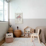 A rectangular, flatweave washable rug in beige, pink, and gray tones with a minimalistic geometric pattern, kids rugs and carpets singapore