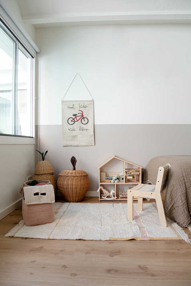 A rectangular, flatweave washable rug in beige, pink, and gray tones with a minimalistic geometric pattern, kids rugs and carpets singapore