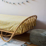 A round vintage blue pouf made of cotton, with a textured surface and a visible carrying handle, kids bean bags and poufs in Singapore