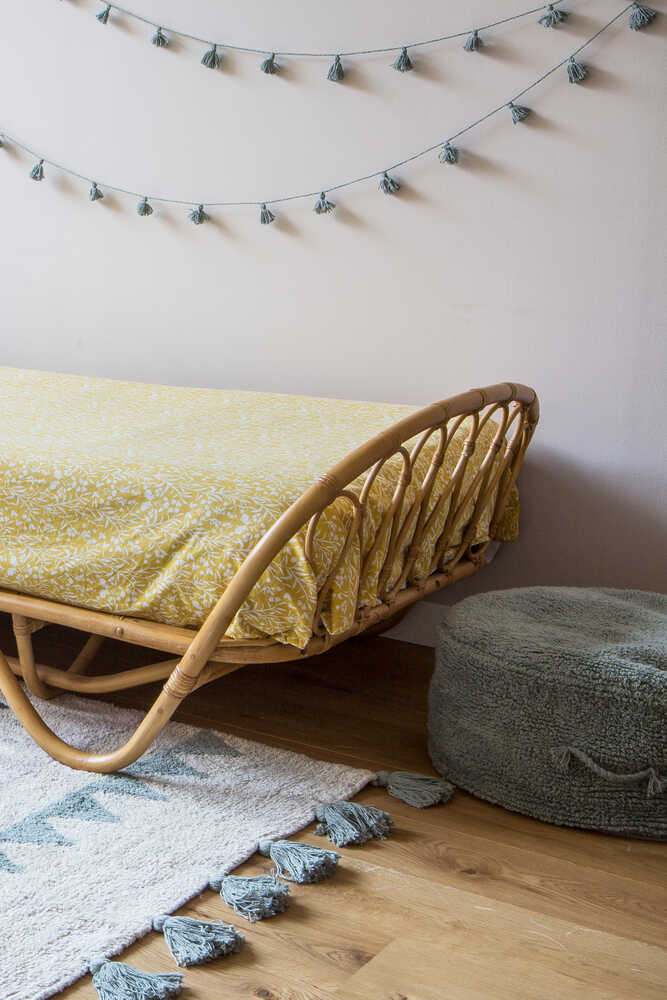 A round vintage blue pouf made of cotton, with a textured surface and a visible carrying handle, kids bean bags and poufs in Singapore