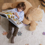 A plush toy resembling a sleepy bear with soft fur in honey-coloured tones, featuring a zipper on its bottom for removing the inner filler, kids bean bags and poufs Singapore, lorena canals singapore
