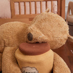 A plush toy resembling a sleepy bear with soft fur in honey-coloured tones, featuring a zipper on its bottom for removing the inner filler, kids bean bags and poufs Singapore, lorena canals singapore