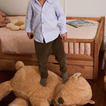 A plush toy resembling a sleepy bear with soft fur in honey-coloured tones, featuring a zipper on its bottom for removing the inner filler, kids bean bags and poufs Singapore, lorena canals singapore
