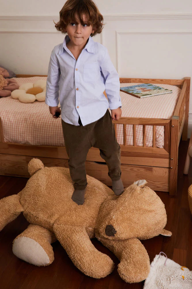A plush toy resembling a sleepy bear with soft fur in honey-coloured tones, featuring a zipper on its bottom for removing the inner filler, kids bean bags and poufs Singapore, lorena canals singapore
