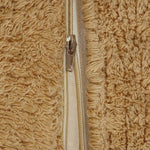 A plush toy resembling a sleepy bear with soft fur in honey-coloured tones, featuring a zipper on its bottom for removing the inner filler, kids bean bags and poufs Singapore, lorena canals singapore