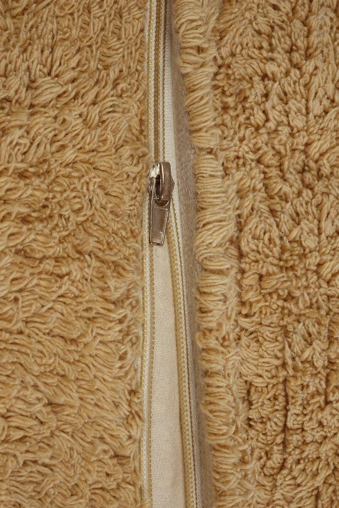 A plush toy resembling a sleepy bear with soft fur in honey-coloured tones, featuring a zipper on its bottom for removing the inner filler, kids bean bags and poufs Singapore, lorena canals singapore