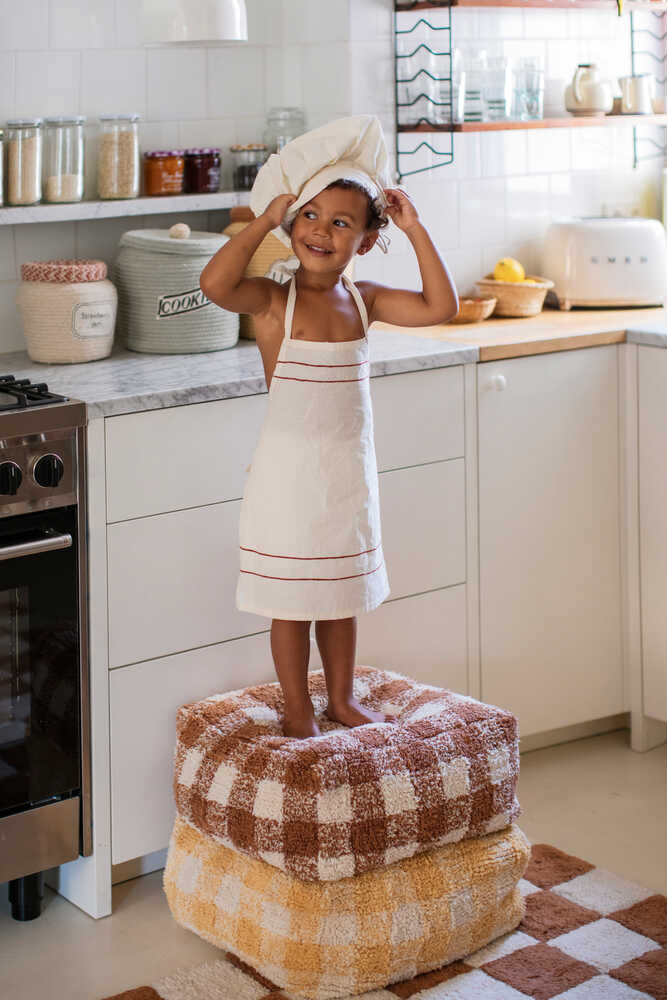 A square-shaped pouf with a brown and white checkered pattern, designed for children's rooms, kids bean bags and poufs Singapore
