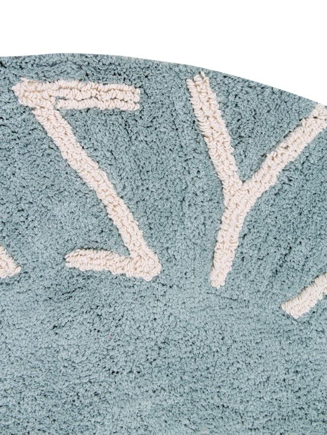 A round blue rug with the letters of the alphabet in white arranged around the edge. kids rugs singapore