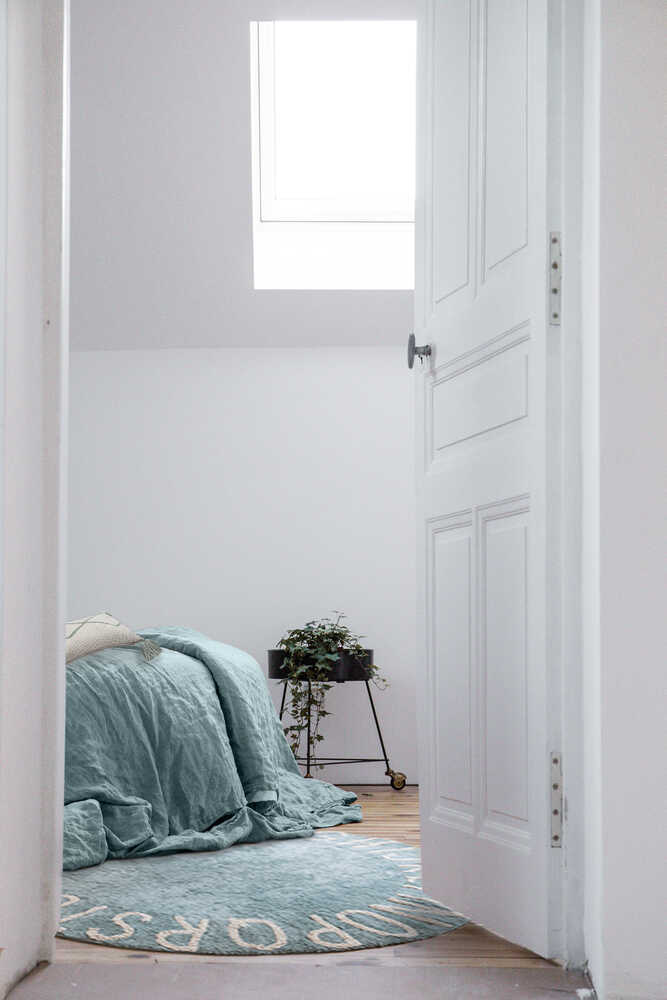 A round blue rug with the letters of the alphabet in white arranged around the edge. kids rugs singapore