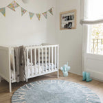 A round blue rug with the letters of the alphabet in white arranged around the edge. kids rugs singapore