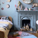 A round wool rug with a colorful pie chart design, featuring shades of green, blue, red, and gray, rainbow rug, kids rugs and carpets Singapore