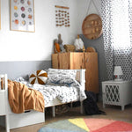 A round wool rug with a colorful pie chart design, featuring shades of green, blue, red, and gray, rainbow rug, kids rugs and carpets Singapore