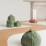 A round bean bag chair with pink and mauve vertical stripes, featuring a handle at the top for easy movement, kids bean bags and poufs in Singapore