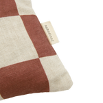 A rectangular linen cushion with a checkered pattern and fruit illustrations in maroon colour, available in Singapore