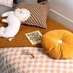 A round kids cushion with a yellow eco-velvet texture, available in Singapore