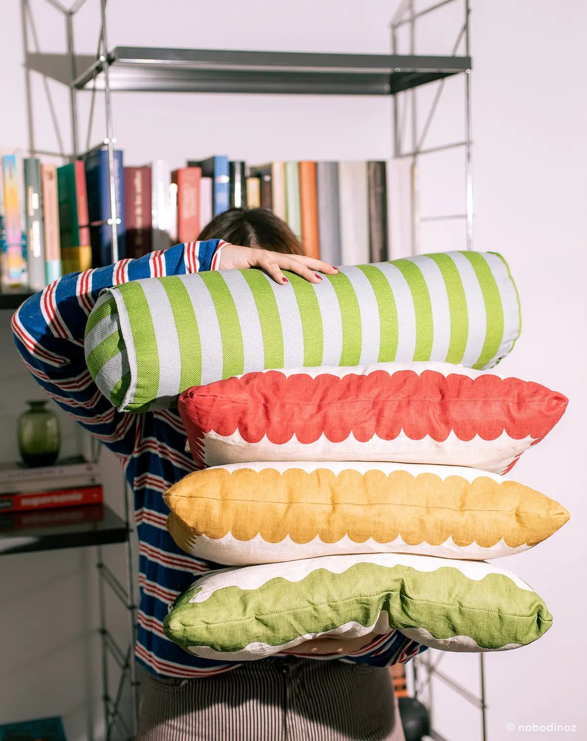 A cylindrical cushion with green and blue stripes, pop decor cushion, bold cushion, eclectic cushions, available in Singapore