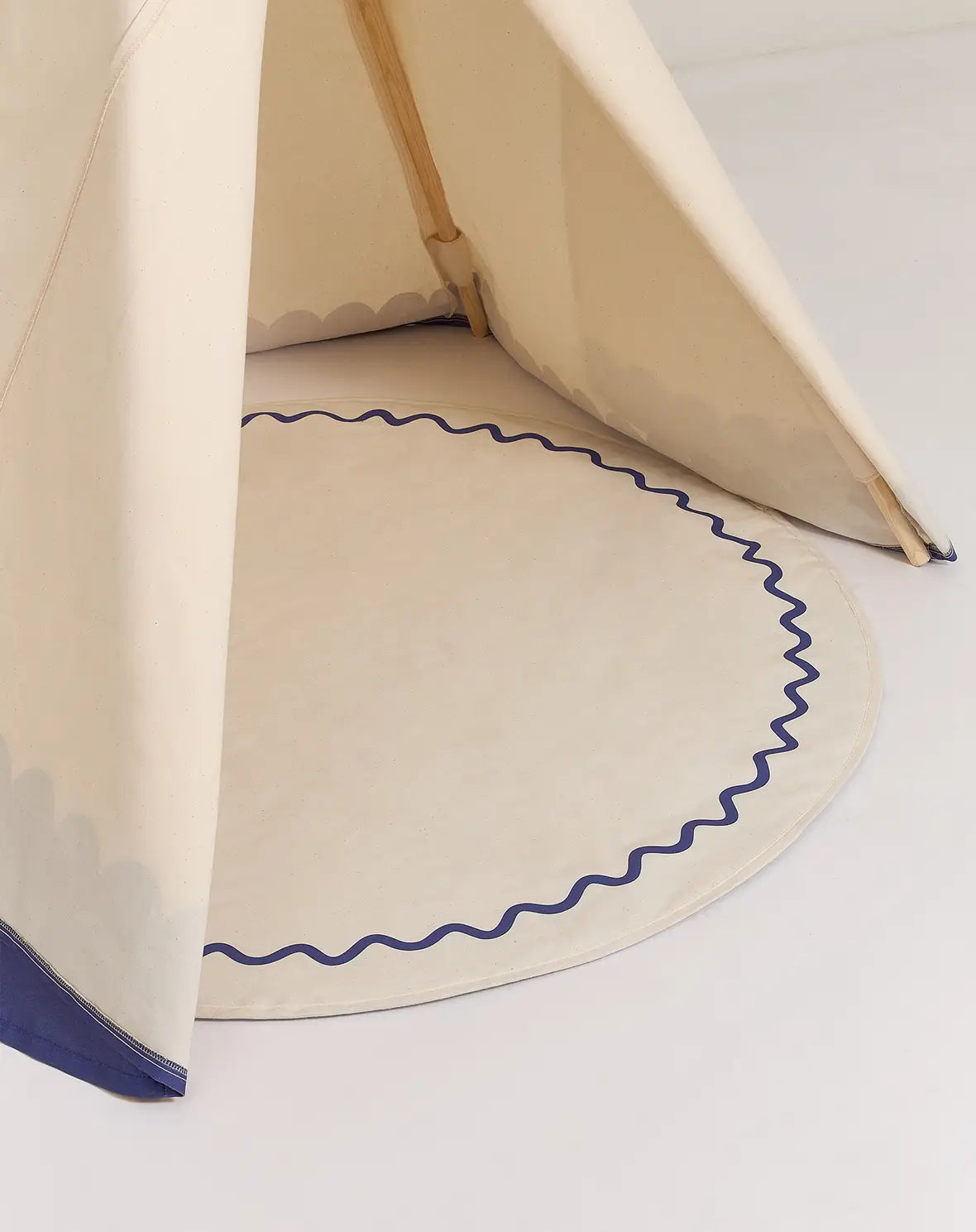A blue and white Nobodinoz Vibes Tipi Arizona play tent made of organic cotton with wooden sticks, designed for children's indoor play, kids tipi tent, children tipi tent, available in Singapore