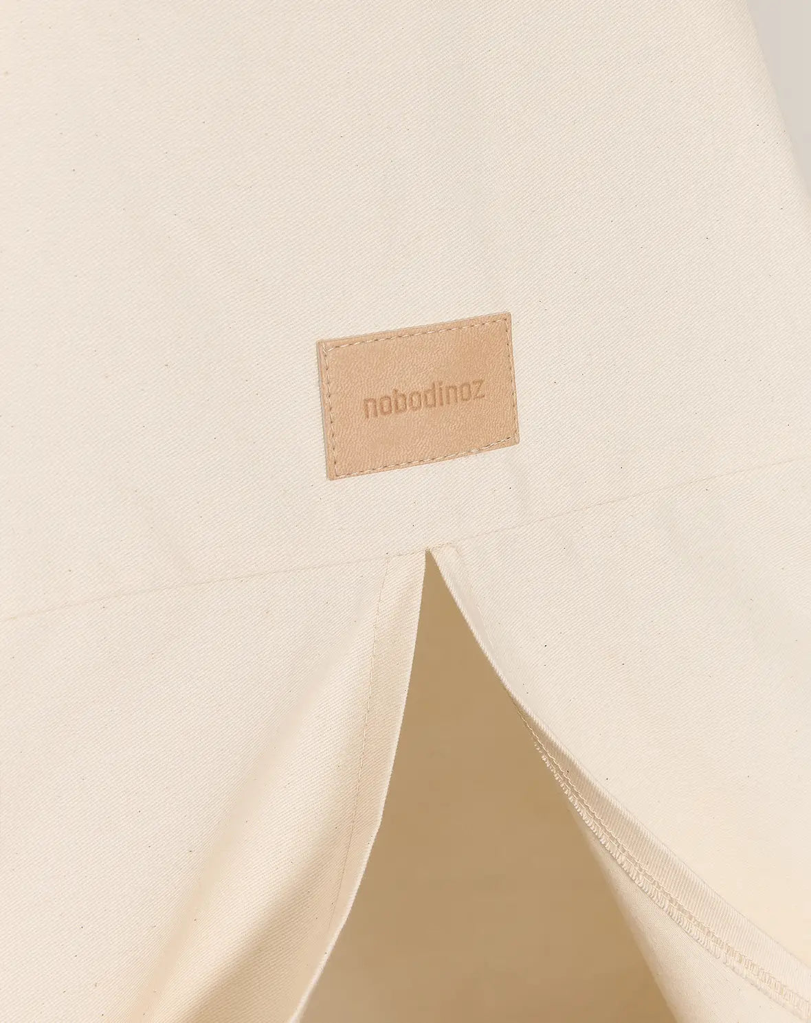 A blue and white Nobodinoz Vibes Tipi Arizona play tent made of organic cotton with wooden sticks, designed for children's indoor play, kids tipi tent, children tipi tent, available in Singapore