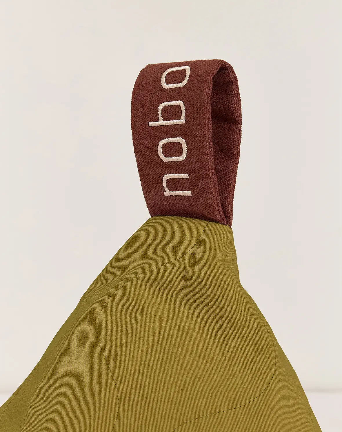 A green quilted long beanbag with an embroidered handle, kids bean bags and poufs Singapore