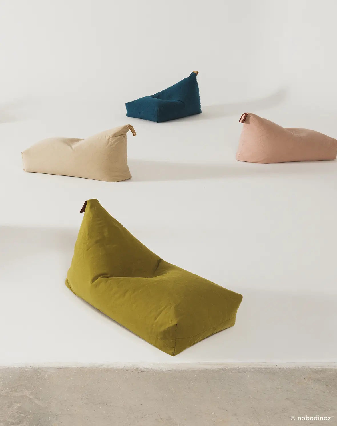 A green quilted long beanbag with an embroidered handle, kids bean bags and poufs Singapore