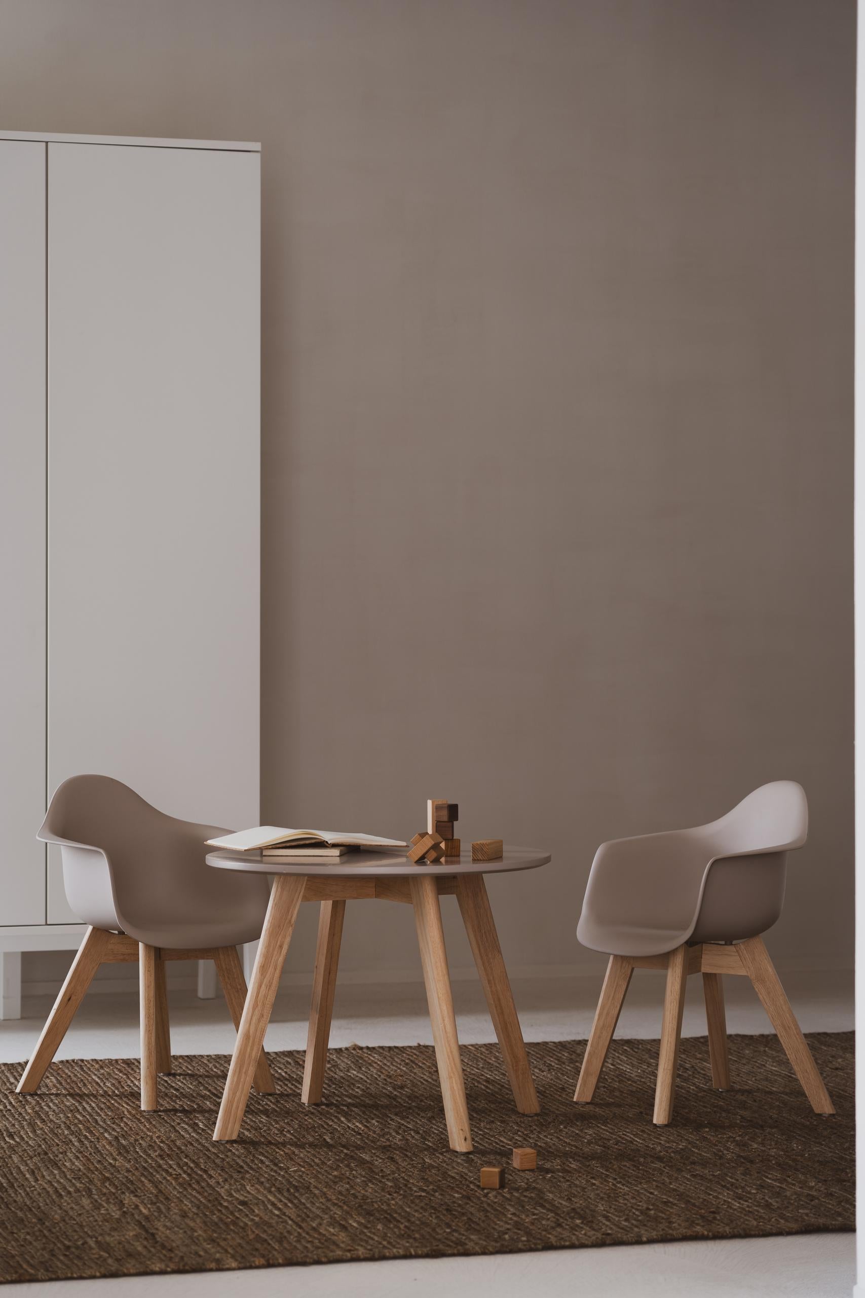 A gray children's play chair with wooden legs designed in a modern style, suitable for toddlers.