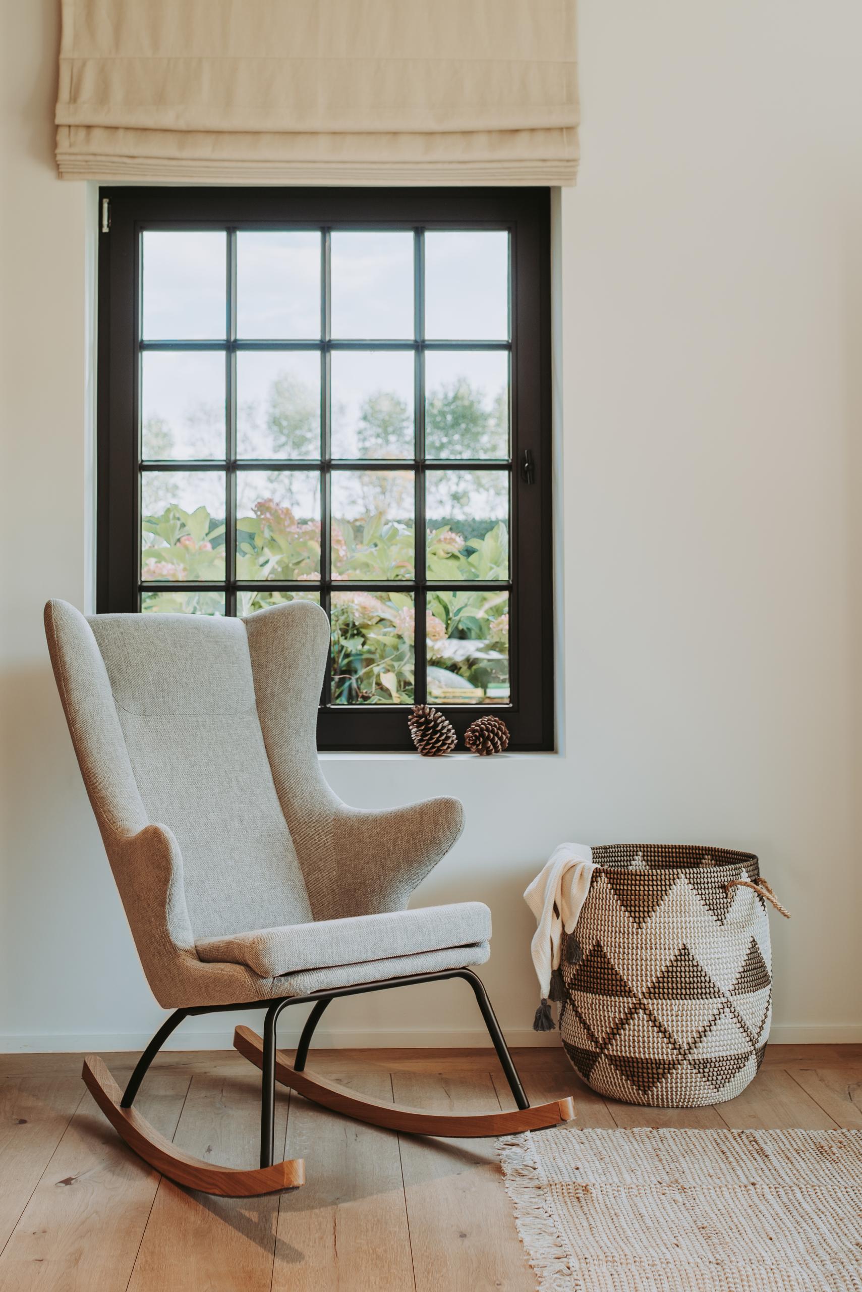Gray rocking chair with black legs on a wooden floor, available in singapore