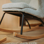 Gray rocking chair with black legs on a wooden floor, available in singapore
