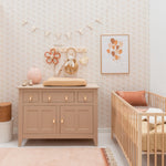 A hand-tufted pink rug with a textured design and fringed edges on the sides. kids rugs singapore