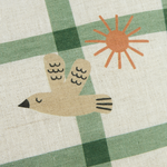 A rectangular linen kids cushion with a green windowpane pattern and a small bird illustration, available in Singapore