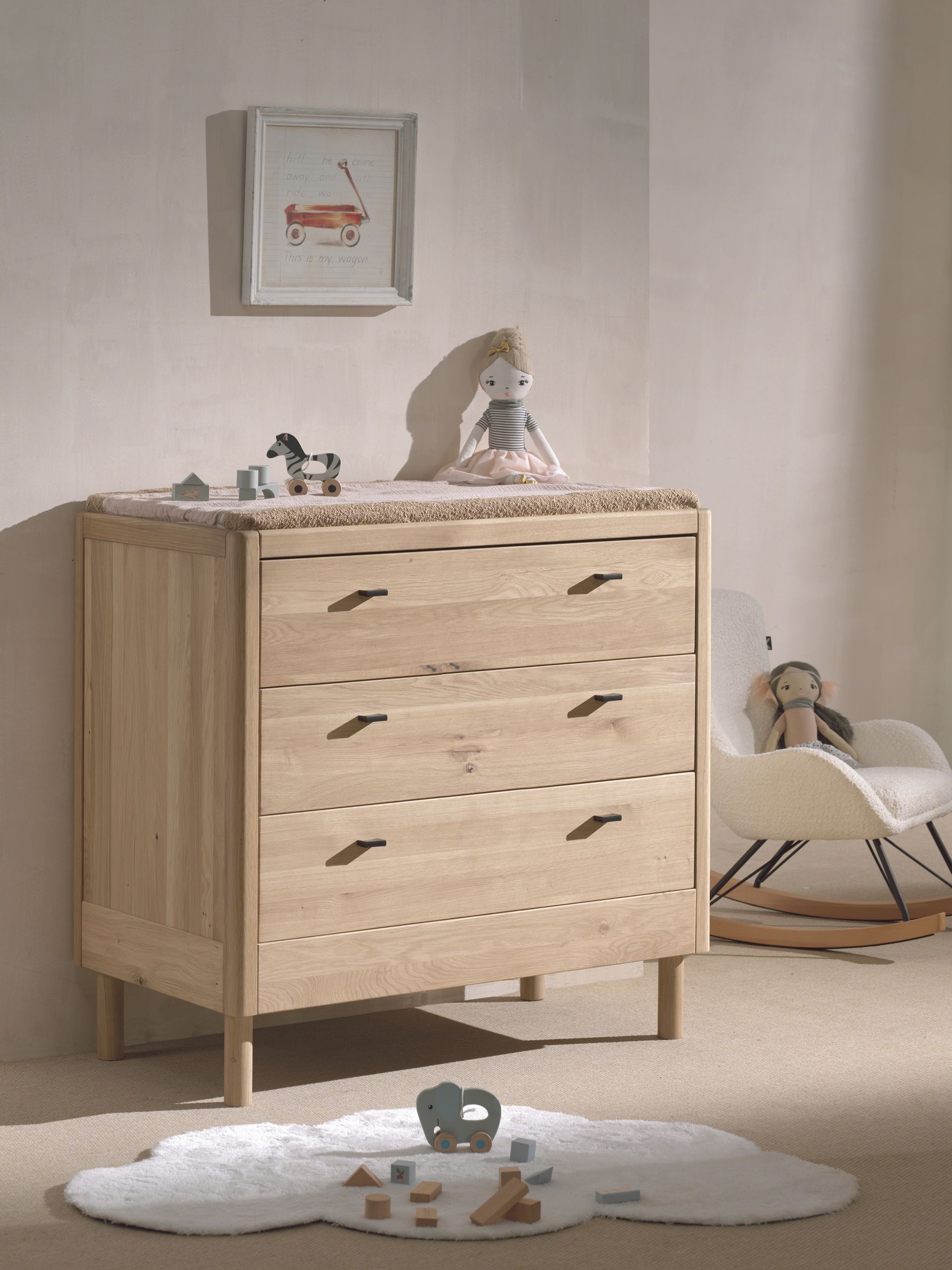 A three-drawer chest made of oak wood, with a natural wood finish and metal handles. available in singapore