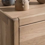 A three-drawer chest made of oak wood, with a natural wood finish and metal handles. available in singapore