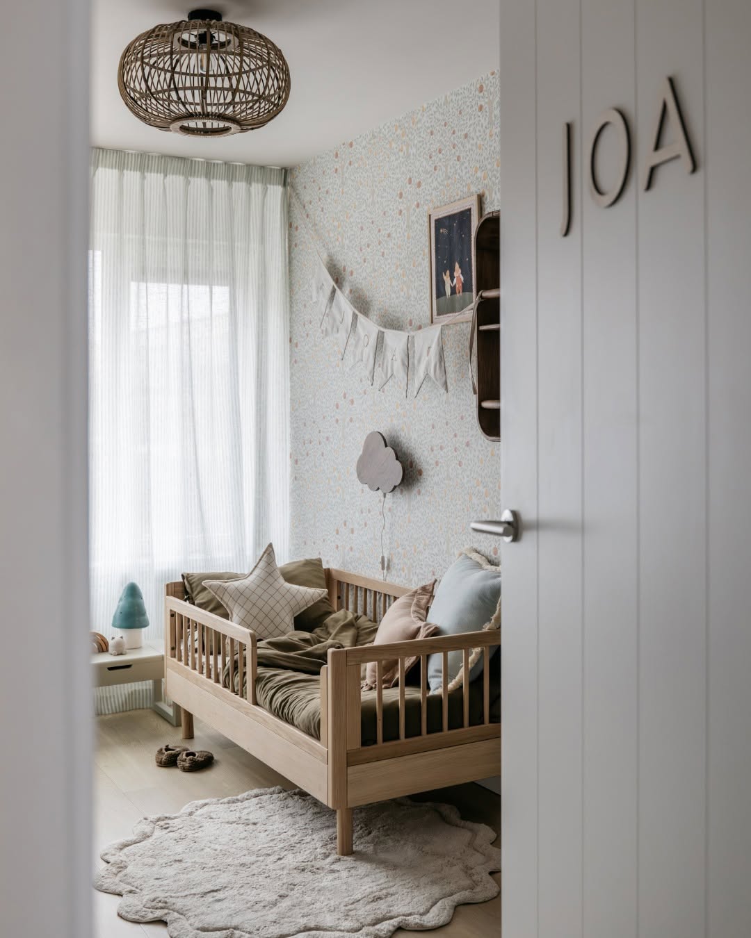 A toddler bed made from European oak with protective railings on all around, featuring a natural wood finish. Available in Singapore.
