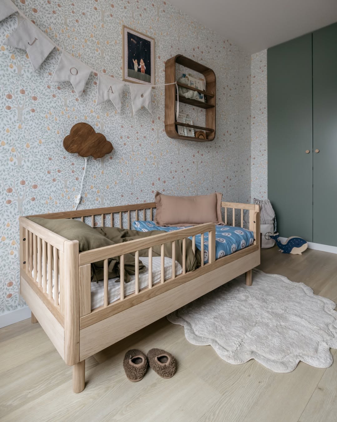 A toddler bed made from European oak with protective railings on all around, featuring a natural wood finish. Available in Singapore.
