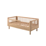 A toddler bed made from European oak with protective railings on all around, featuring a natural wood finish. Available in Singapore.