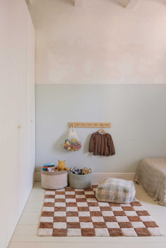 A rectangular rug with a traditional checkerboard pattern in toffee and cream colors, checkered rug, kids rug singapore