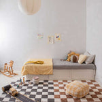 A rectangular rug with a traditional checkerboard pattern in toffee and cream colors, checkered rug, kids rug singapore